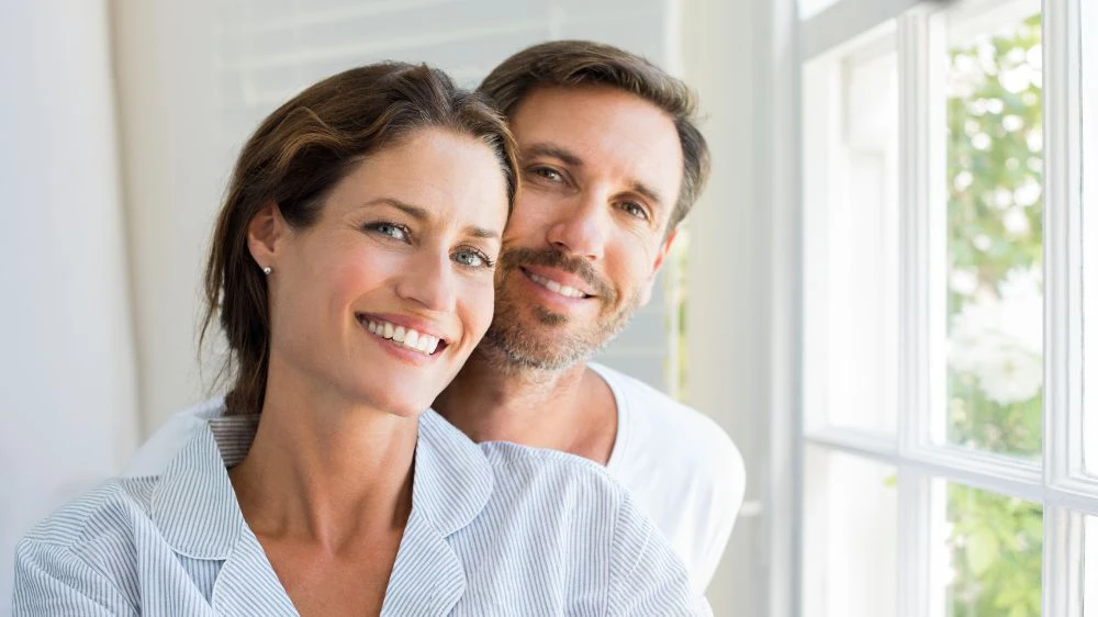 happy man and woman smiling with nice teeth
