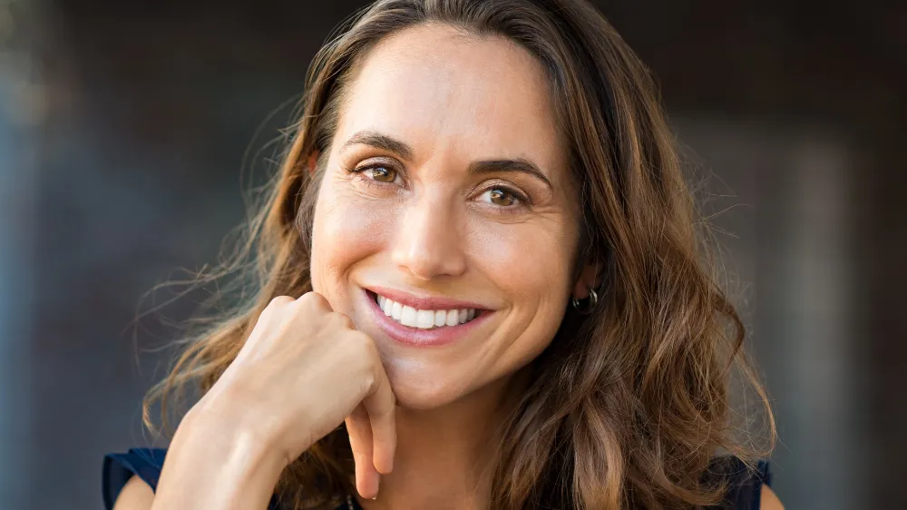 happy woman smiling after cosmetic dentistry