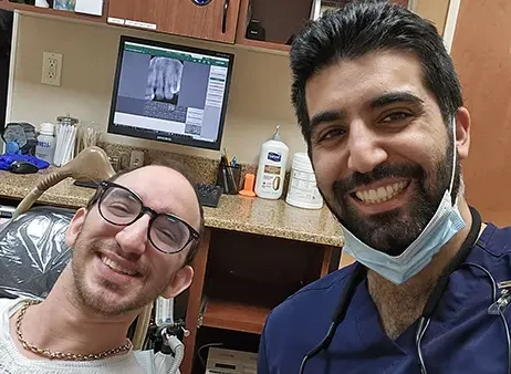 Plainview Dentist Dr. Adhami With A Patient